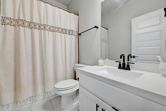 bathroom featuring vanity, a shower with shower curtain, tile patterned flooring, and toilet