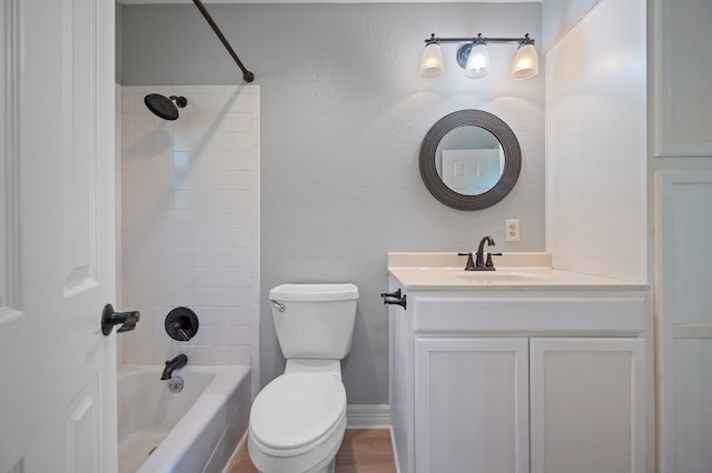 full bathroom with tiled shower / bath combo, vanity, and toilet