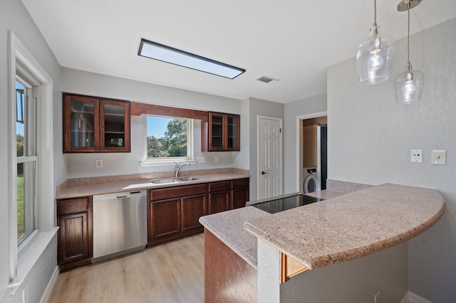 kitchen with dishwasher, pendant lighting, black electric cooktop, sink, and light hardwood / wood-style flooring