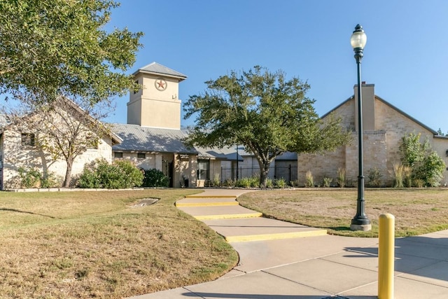 view of home's community with a yard