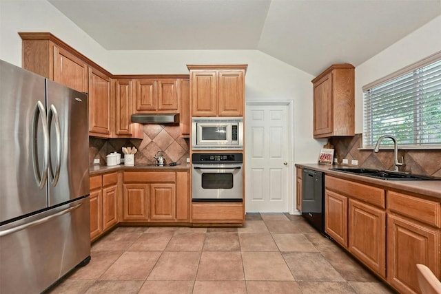 kitchen featuring vaulted ceiling, black appliances, sink, tasteful backsplash, and light tile patterned floors