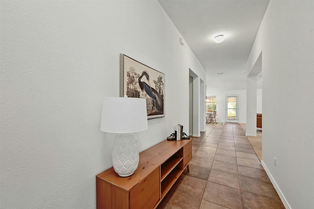 hall with tile patterned flooring