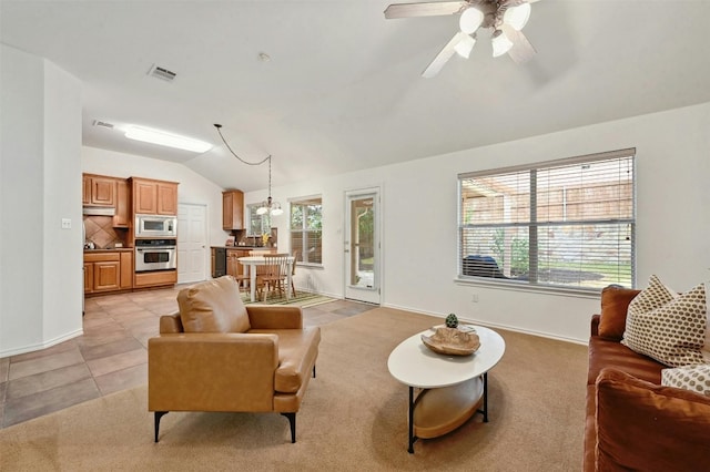 living room with lofted ceiling, light tile patterned floors, and ceiling fan