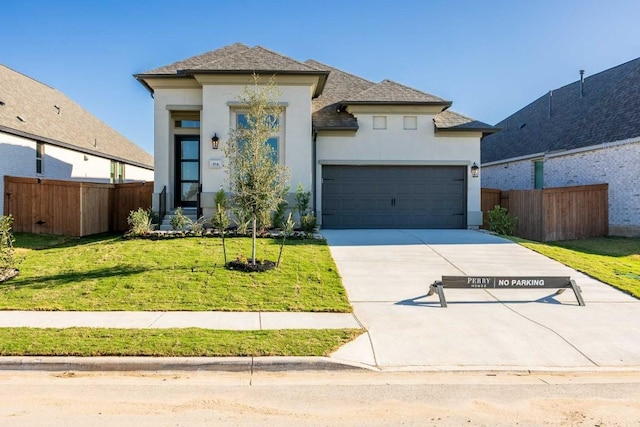 view of front of house with a front yard and a garage