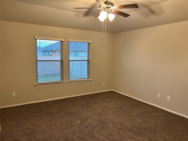 carpeted spare room with ceiling fan