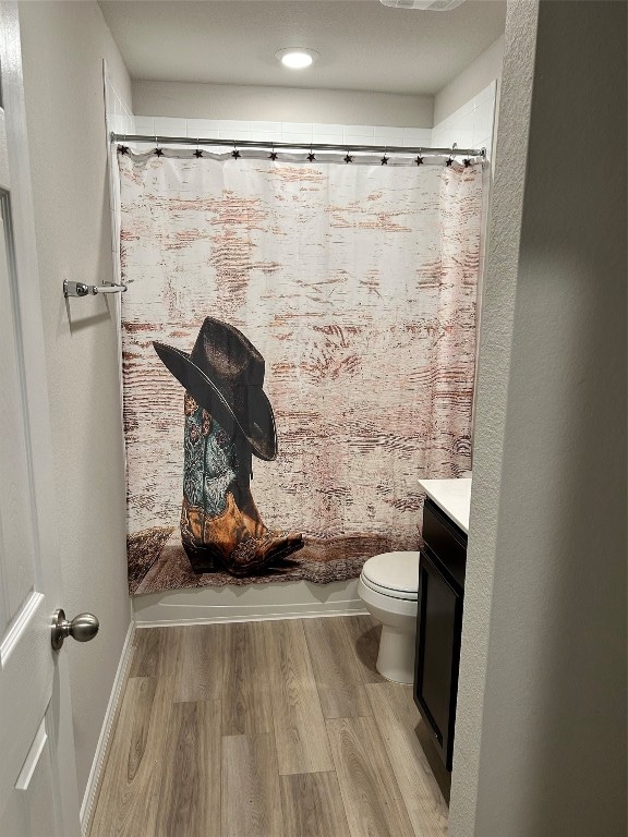 full bathroom with toilet, shower / bath combo, vanity, and hardwood / wood-style floors