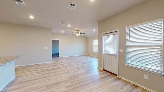 unfurnished living room featuring light hardwood / wood-style flooring and ceiling fan