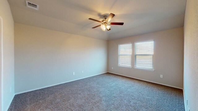 carpeted empty room featuring ceiling fan