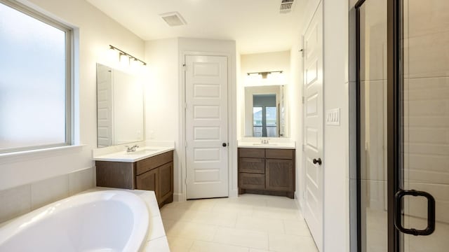 bathroom with tile patterned flooring, vanity, and separate shower and tub