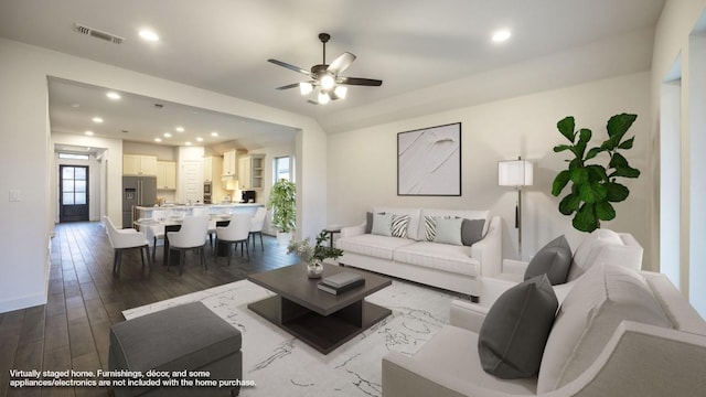 living room with plenty of natural light, hardwood / wood-style floors, and ceiling fan