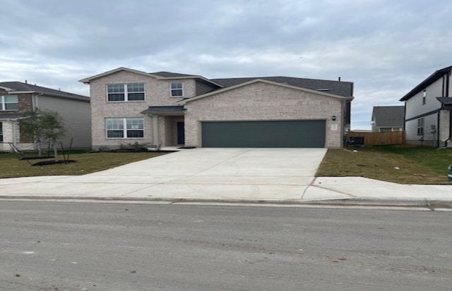 view of front of house featuring a front yard and a garage