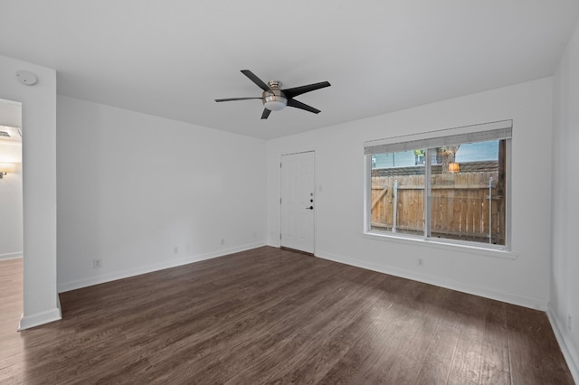 unfurnished room with dark wood-type flooring and ceiling fan