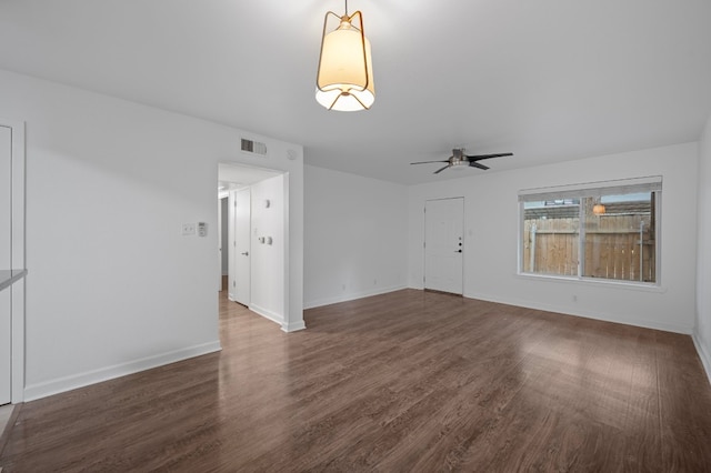 unfurnished living room featuring dark hardwood / wood-style flooring and ceiling fan