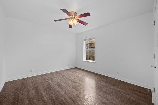 spare room with ceiling fan and dark hardwood / wood-style floors