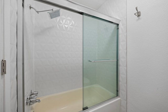 bathroom featuring shower / bath combination with glass door