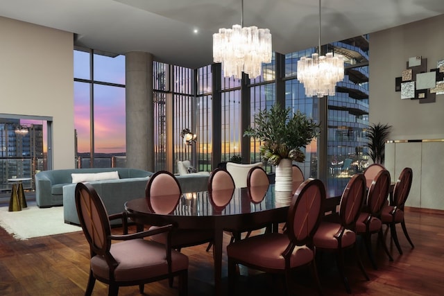 dining area featuring expansive windows, hardwood / wood-style flooring, and an inviting chandelier