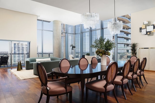 dining area featuring a chandelier, hardwood / wood-style floors, and floor to ceiling windows