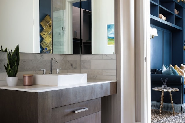 bathroom with vanity and tasteful backsplash