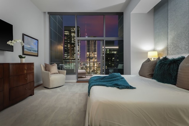 bedroom featuring a wall of windows and carpet