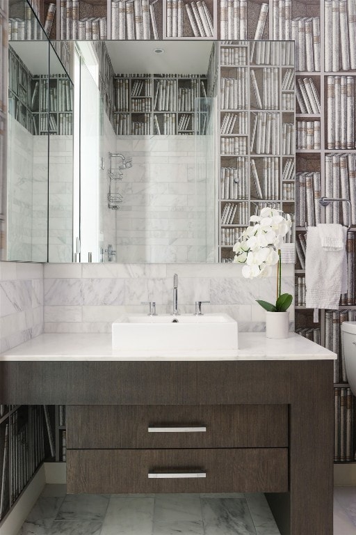 bathroom featuring walk in shower and vanity