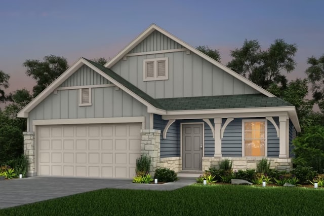 view of front of house with a garage and a yard