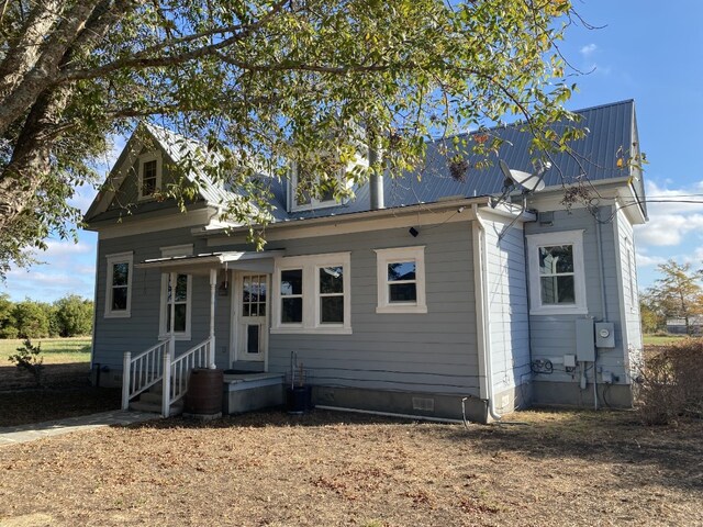 view of front of property with crawl space and metal roof