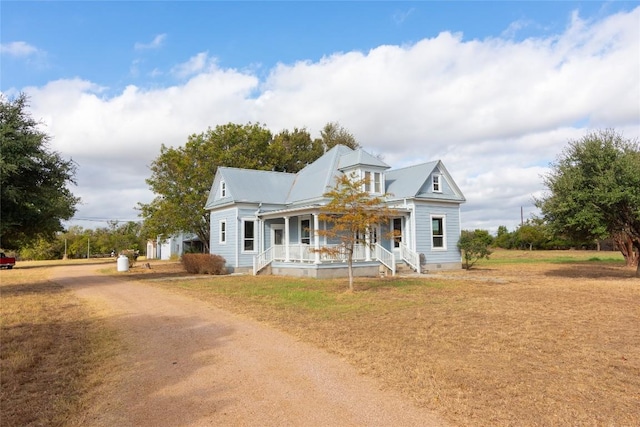 view of front of home featuring a front yard and a porch