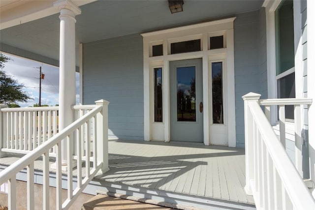 view of exterior entry with a porch