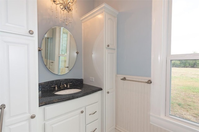 bathroom featuring a wainscoted wall and vanity