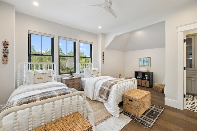 bedroom with ceiling fan, dark hardwood / wood-style floors, and connected bathroom