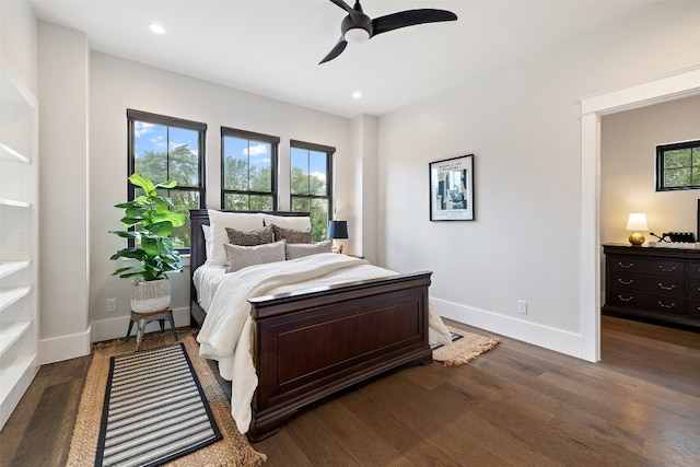 bedroom featuring multiple windows, ceiling fan, and dark wood-type flooring