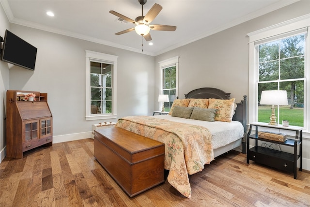 bedroom featuring multiple windows, ceiling fan, and hardwood / wood-style floors