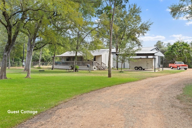 exterior space with a carport, covered porch, and a front yard