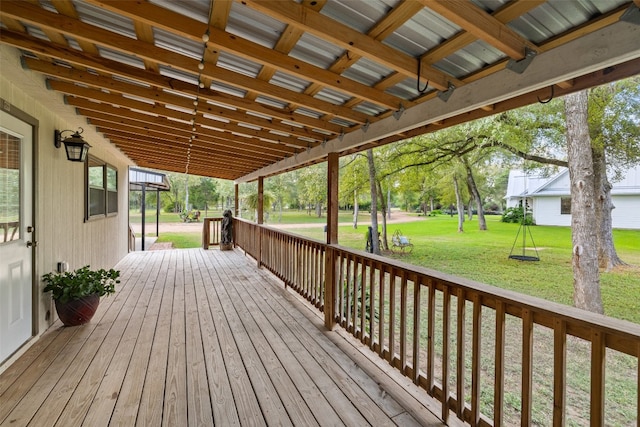 wooden terrace with a lawn