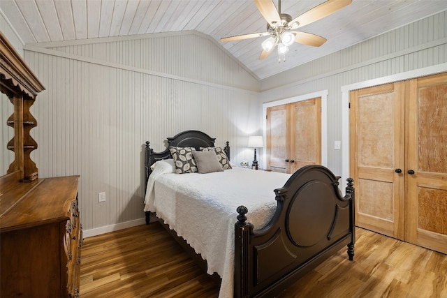 bedroom featuring ceiling fan, hardwood / wood-style floors, wooden ceiling, and lofted ceiling