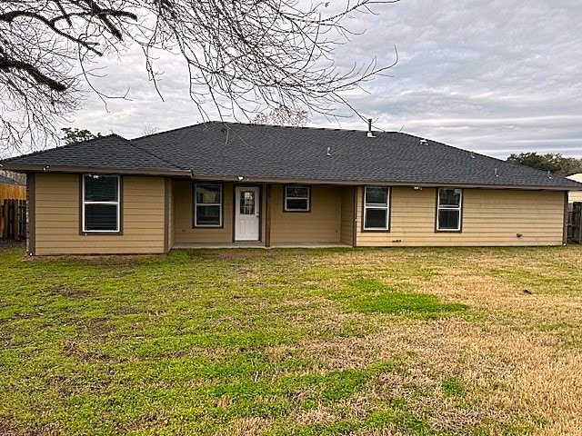 rear view of house with a yard