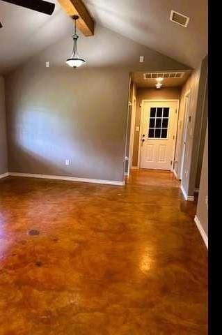 unfurnished room featuring ceiling fan and lofted ceiling with beams