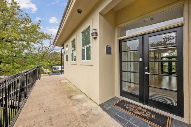 1310 S 1st St Unit 300, Austin, TX 78704 - entrance to property with french doors, stucco siding, a balcony, and a surveillance system