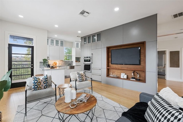 1310 S 1st St Unit 300, Austin, TX 78704 - living room featuring light wood-type flooring and recessed lighting