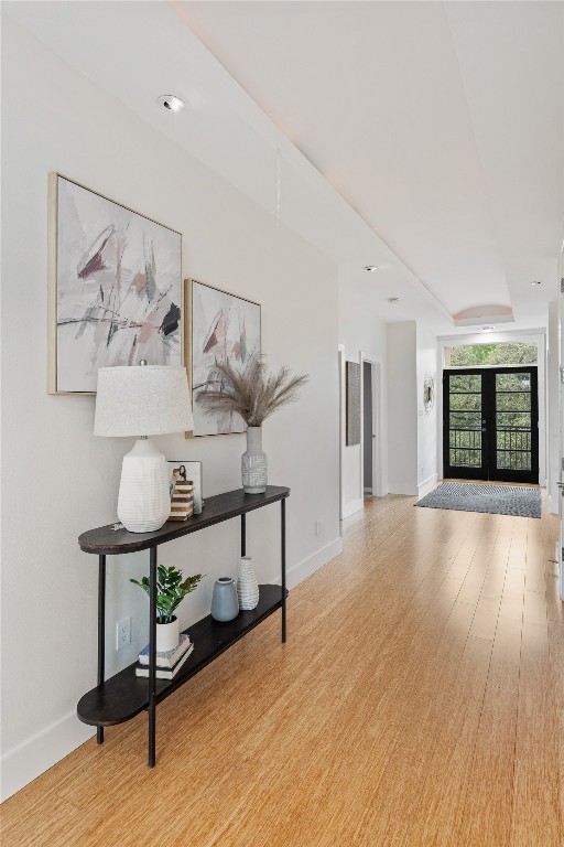 hall featuring french doors and hardwood / wood-style flooring