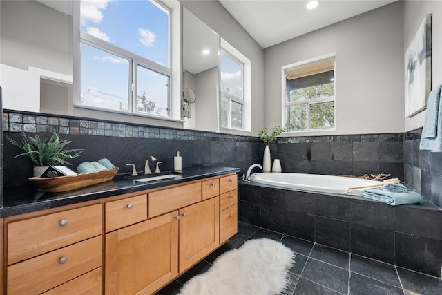 bathroom with vanity, tiled bath, and tile patterned floors