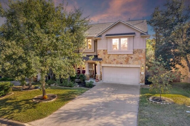 view of front of property with a garage and a yard