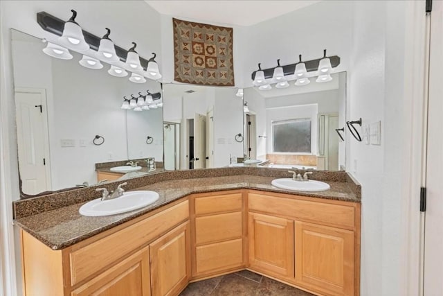 bathroom featuring tile patterned flooring, a sink, and double vanity