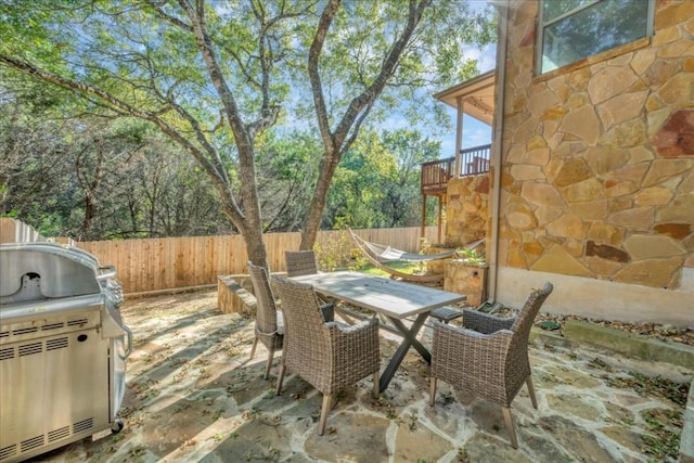 view of patio featuring fence and outdoor dining space