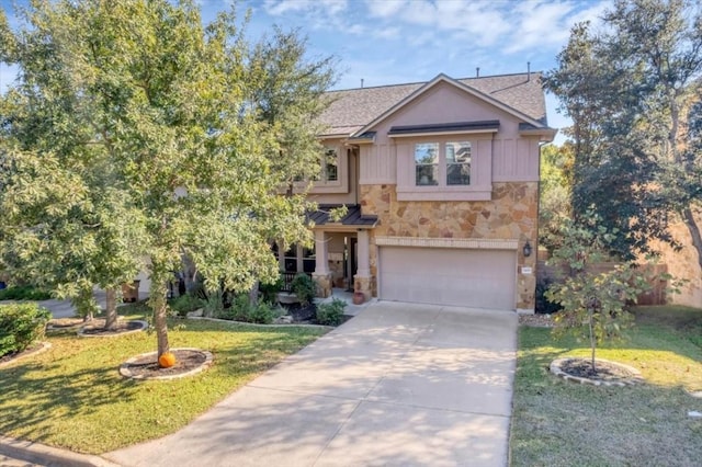 view of front facade with a garage, stone siding, a front lawn, and concrete driveway