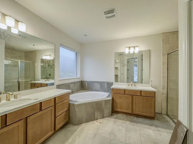 bathroom with tile patterned flooring, plus walk in shower, and vanity