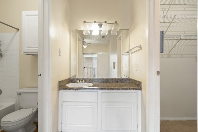 full bathroom featuring ceiling fan, vanity, toilet, and bathtub / shower combination