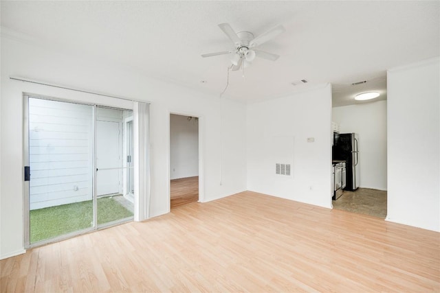 unfurnished living room with ceiling fan, visible vents, and light wood-style floors