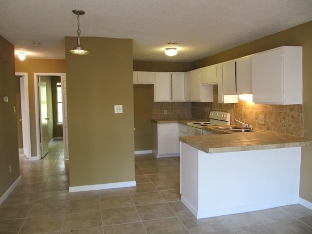 kitchen featuring white cabinets, pendant lighting, kitchen peninsula, and white electric range