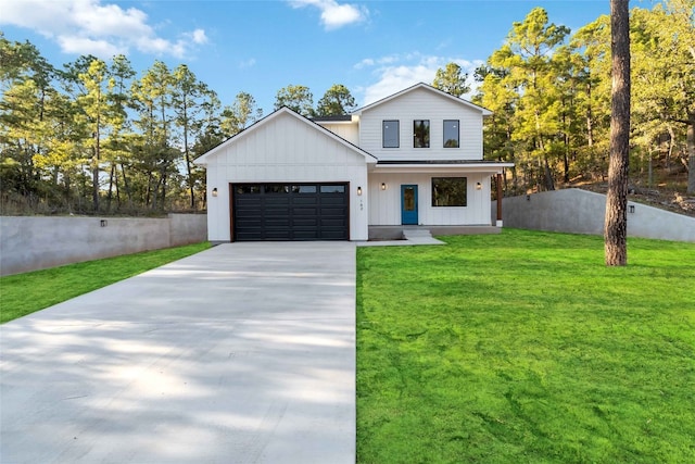 modern inspired farmhouse with a front lawn and a garage